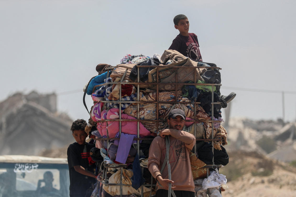 Displaced Palestinians fleeing northern Gaza travel in a donkey-drawn cart loaded with their belongings while they head south as the Israeli military prepares to relocate residents to the southern part of the enclave, in Gaza City, August 18, 2025. (Reuters)