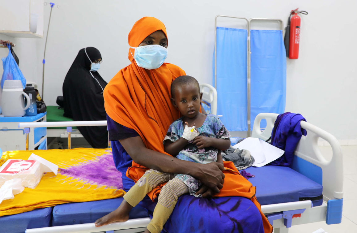 A Somali woman holds her son affected with diphtheria, inside a ward at De Martino Public Hospital, following a diphtheria outbreak, in Mogadishu, Somalia August 13, 2025. REUTERS/Feisal Omar