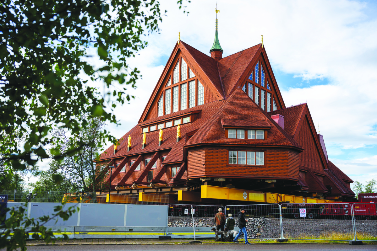 People look at the Kiruna Church, a Sami style wooden Swedish Lutheran church, called Kiruna Kyrka in Swedish, in Kiruna, Sweden, on Monday. (AP)