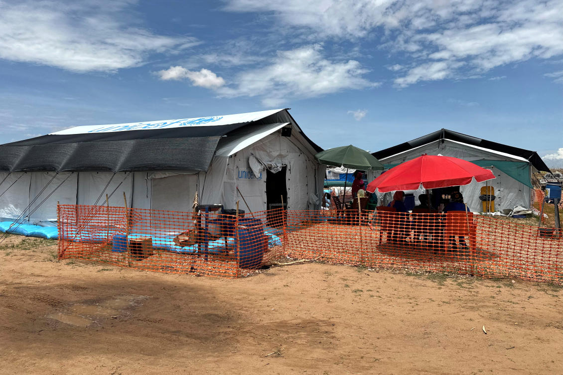 People sit outside the cholera isolation centre in at the refugee camps of western Sudan, in Tawila city in Darfur, on August 14, 2025. (File/AFP)