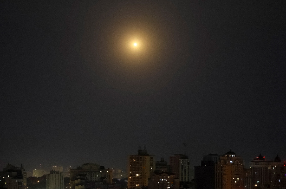 An explosion is seen in the night sky as Ukrainian servicemen fire towards drones during a Russian drone strike in Kyiv, Ukraine. (Reuters)