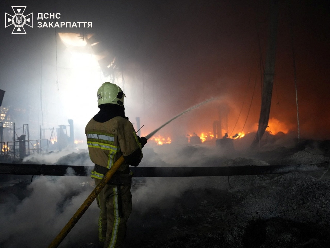 A firefighter works at the site where a Flextronics factory was hit by a Russian missile strike in Mukachevo, Zakarpattia region, Ukraine. (Handout