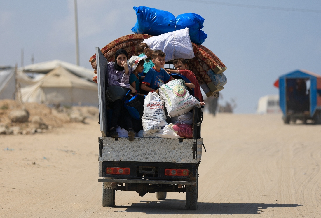 Displaced Palestinians fleeing northern Gaza ride with their belongings as they head south, amid an Israeli military operation, in Gaza City. (Reuters)