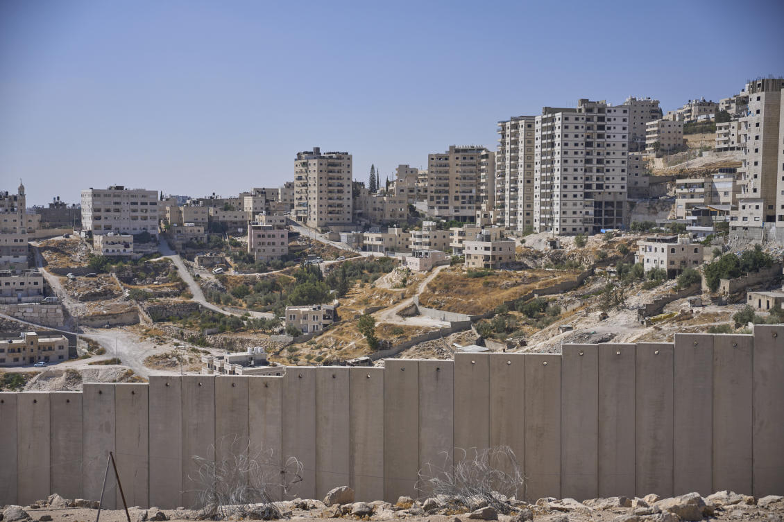 Israel's separation wall next to the Arab neighborhood of Al-Eizariya, near where the Israeli government says housing units will be built as part of the E1 settlement development project. (AP)