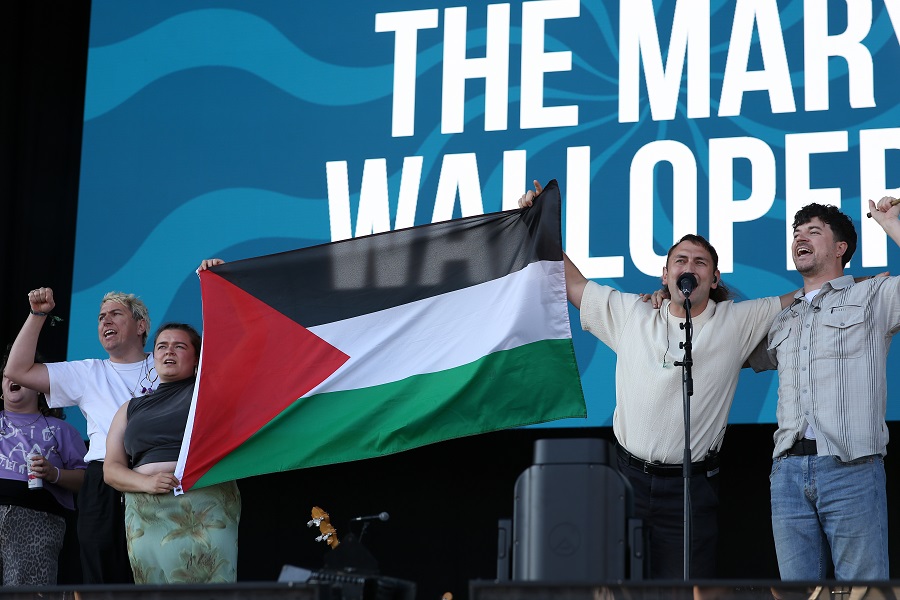 The Mary Wallopers hold a Palestinian flag as they protest onstage during Day 1 of Victorious Festival on August 22, 2025 in Southsea, England. (Getty Images)
