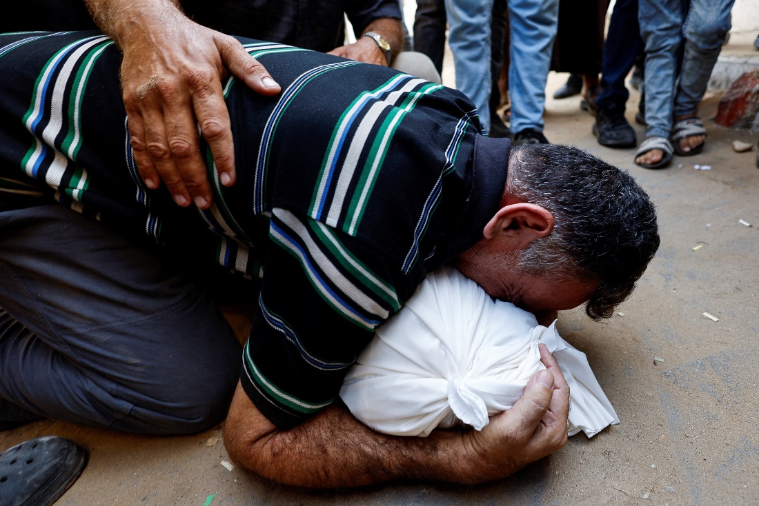 Palestinian father Mahmoud Abedrabo mourns over the body of his son Hamada, who was killed in an Israeli strike, according to medics, at Al Shifa Hospital in Gaza City. (Reuters)
