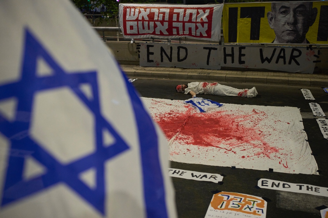 A demonstrator takes part in a performance during a protest against Prime Minister Benjamin Netanyahu's government in Tel Aviv, Israel. (AP)