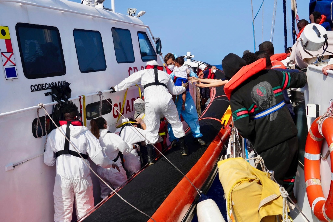 Italian Coast Guard personnel evacuate migrants from the vessel NADIR operated by the organization RESQSHIP, off the coast of the Sicilian Island of Lampedusa. (Handout by RESQSHIP)