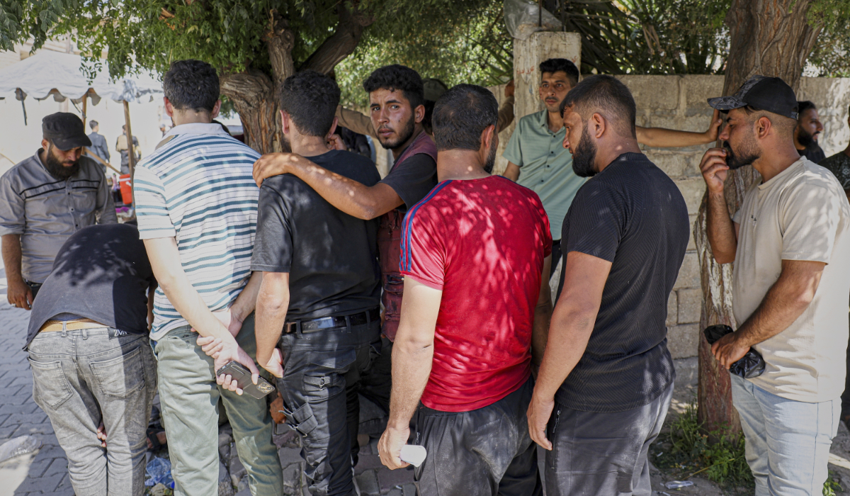 Young Kurdish men line up to sign up to join Syrian government's General Security forces at a police station in Afrin, Syria, an area in the country's north from which Kurds were forcibly displaced years ago, Thursday Aug. 21, 2025. (AP)