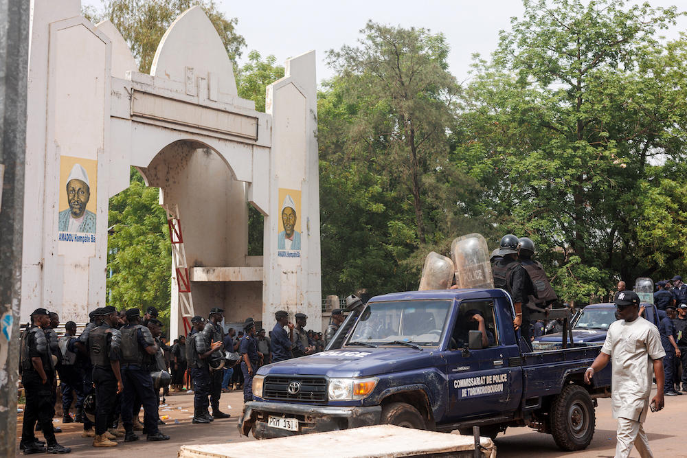 Above, Malian policemen form a cordon as pro-junta demonstrators hold banners and chant slogans while opposing political parties protest in front of the Palais de la Culture Amadou Hampate in Bamako on May 3, 2025. (AFP)