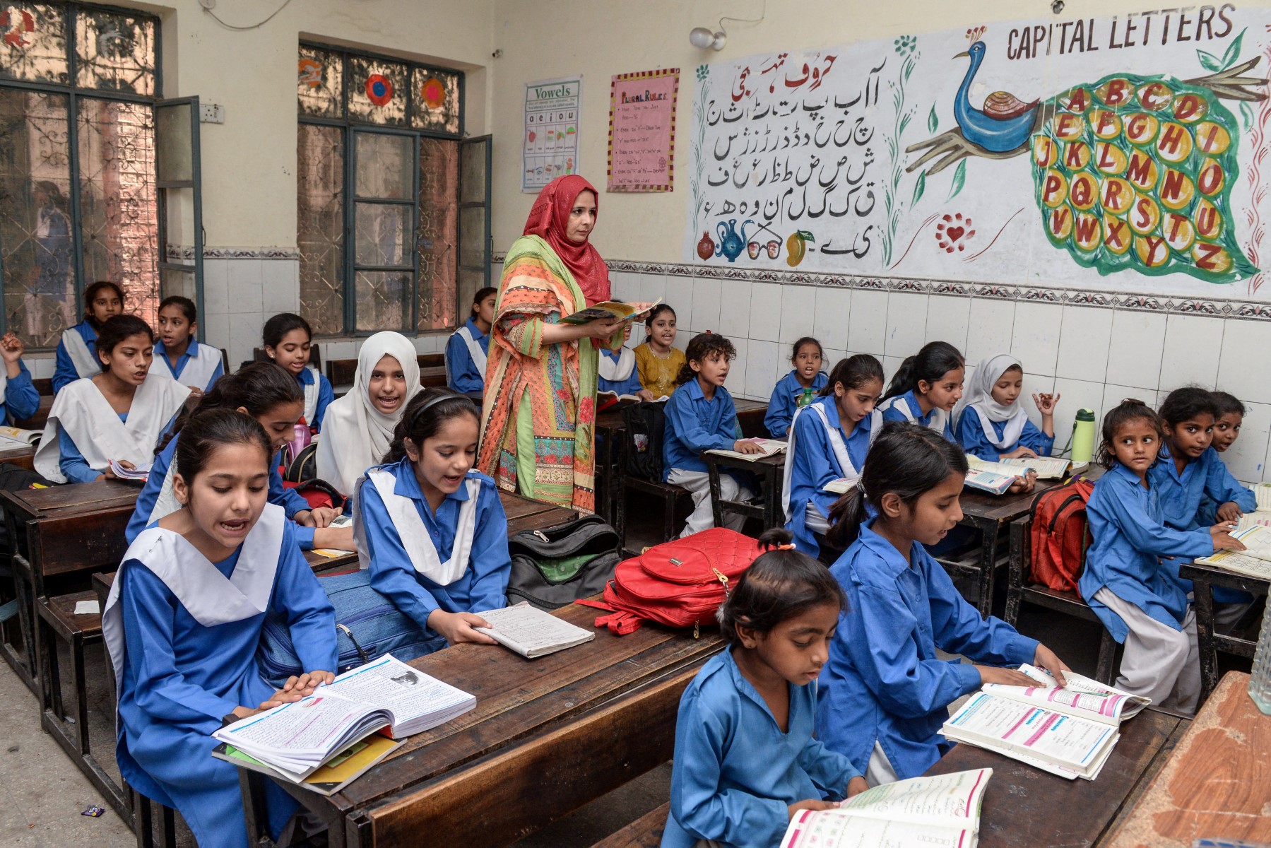 Students attend last day of class at a school before their early summer vacation ordered by provincial Punjab government following series of heatwaves, in Lahore on May 24, 2024. (AFP)