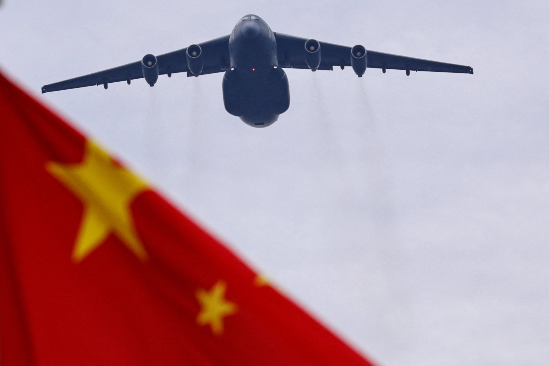 A Xian Y-20 transport aircraft flies past a Chinese national flag during a flyover rehearsal ahead of a military parade to mark the 80th anniversary of the end of World War Two, in Beijing, China. (Reuters)