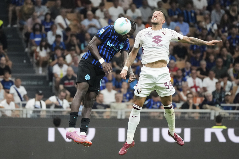 Inter Milan’s Marcus Thuram, left, scores his side’s 4th goal past Torino’s Cristiano Biraghi during a Serie A match between Inter Milan and Torino, at the San Siro stadium in Milan Monday. (AP)