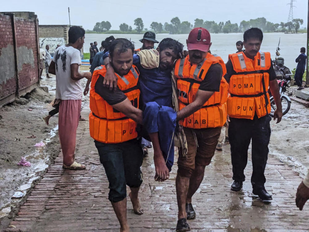 Rescue workers help a villager after evacuating him with others from a low-lying area in Bahawalnagar district in Pakistan’s Punjab province bordering India on Aug. 26, 2025. (Pakistan’s National Disaster Management Authority via AP)