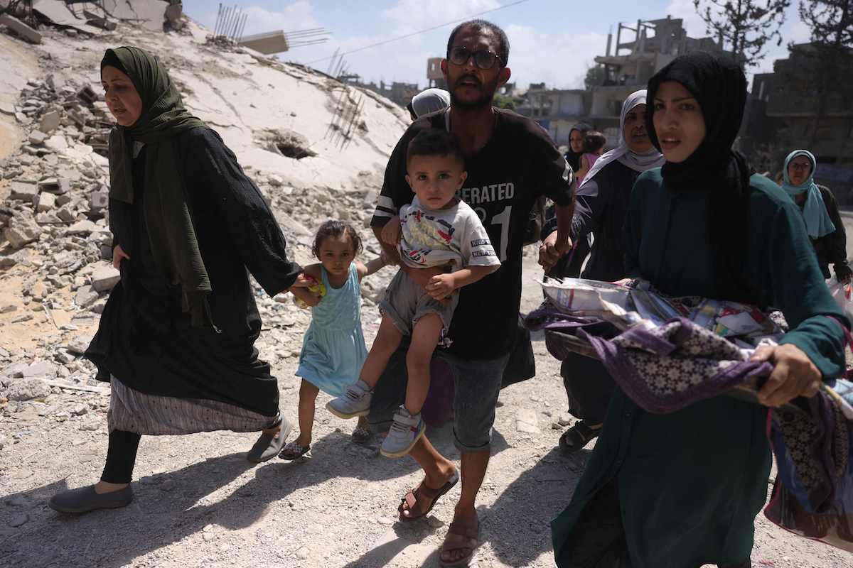 Palestinians flee their homes in Jabalia's Saftawy neighborhood on Tuesday. Ex-European diplomats have condemned the EU for not taking a tougher stance against Israel. (AFP)