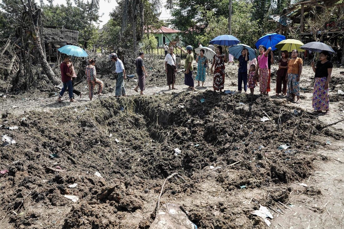 People inspect the damage after bombardments carried out by Myanmar's military in Mrauk U, Myanmar's Rakhine State. (AFP)