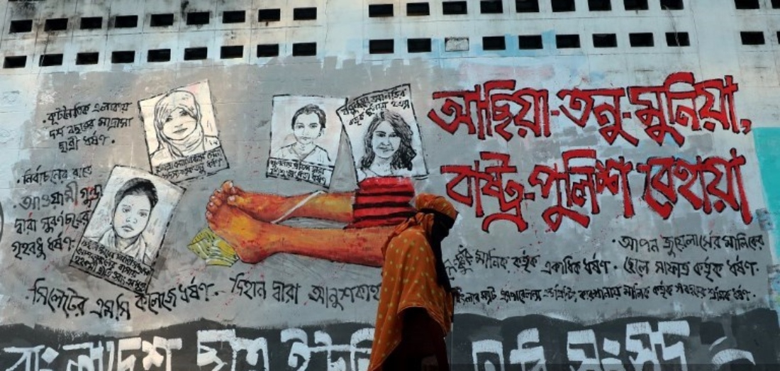 Students paint anti-rape graffiti on a wall in the Dhaka University area, demanding justice for all rapes, including those involving children, in Dhaka, Bangladesh. (NURphoto/AFP)