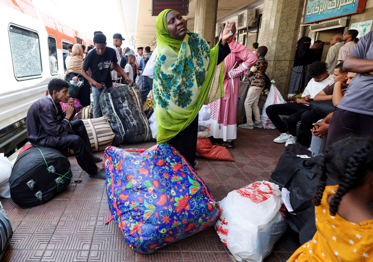 Sudanese families displaced by conflict between the fighting in their country crowd at Cairo’s main station on July 28, 2025, to board a train to Aswan, where buses will take them back to their homes in Khartoum. (REUTERS)