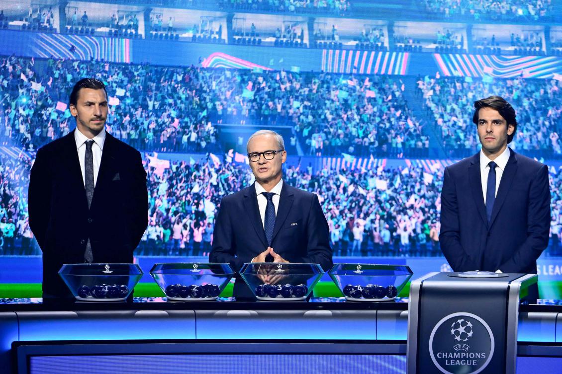 UEFA Deputy Secretary General Giorgio Marchetti delivers a speech next to AC Milan’s Swedish senior adviser Zlatan Ibrahimovic and former Brazilian player Kaka ahead of the draw ceremony for the group stage of the 2025-2026 UEFA Champions League tournament, at the Grimaldi Forum in Monaco on Aug. 28, 2025. (AFP)