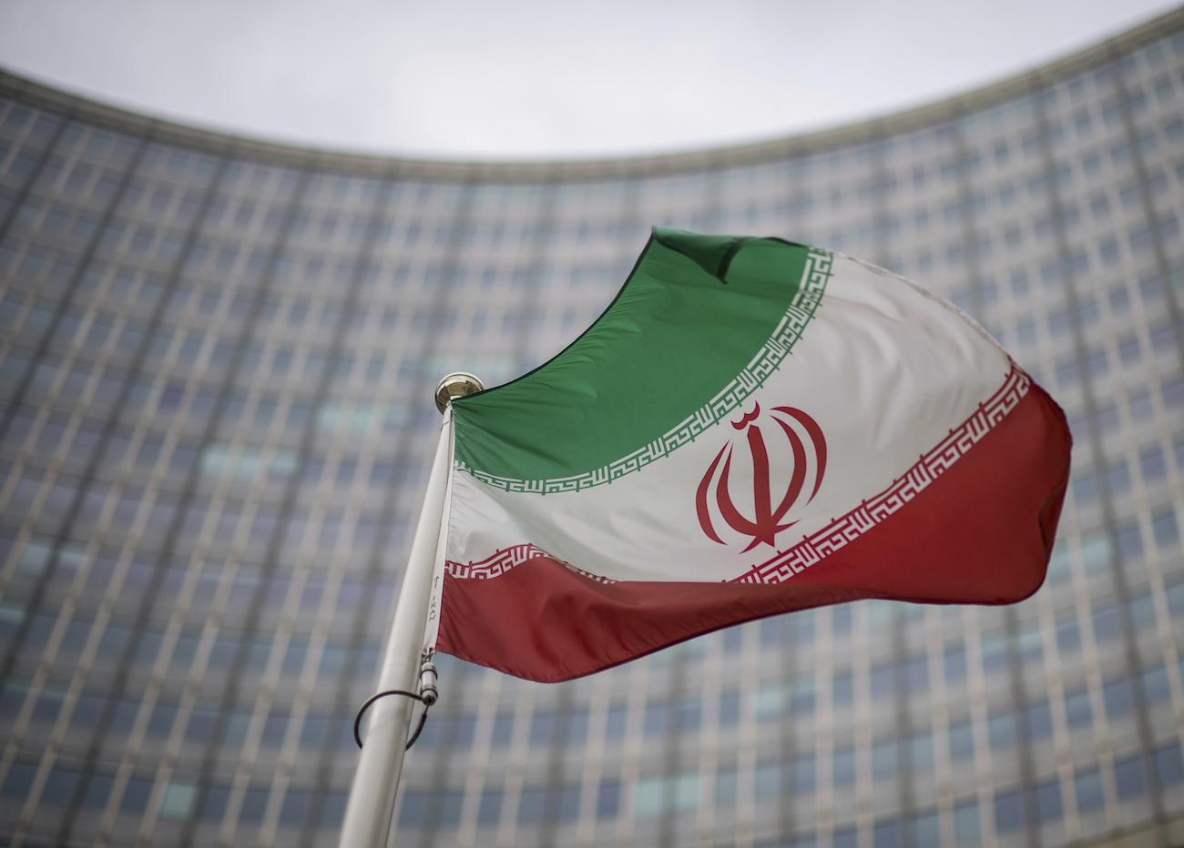A national flag of Iran waves in front of the building of the International Atomic Energy Agency, IAEA, in Vienna, Austria. (AP)