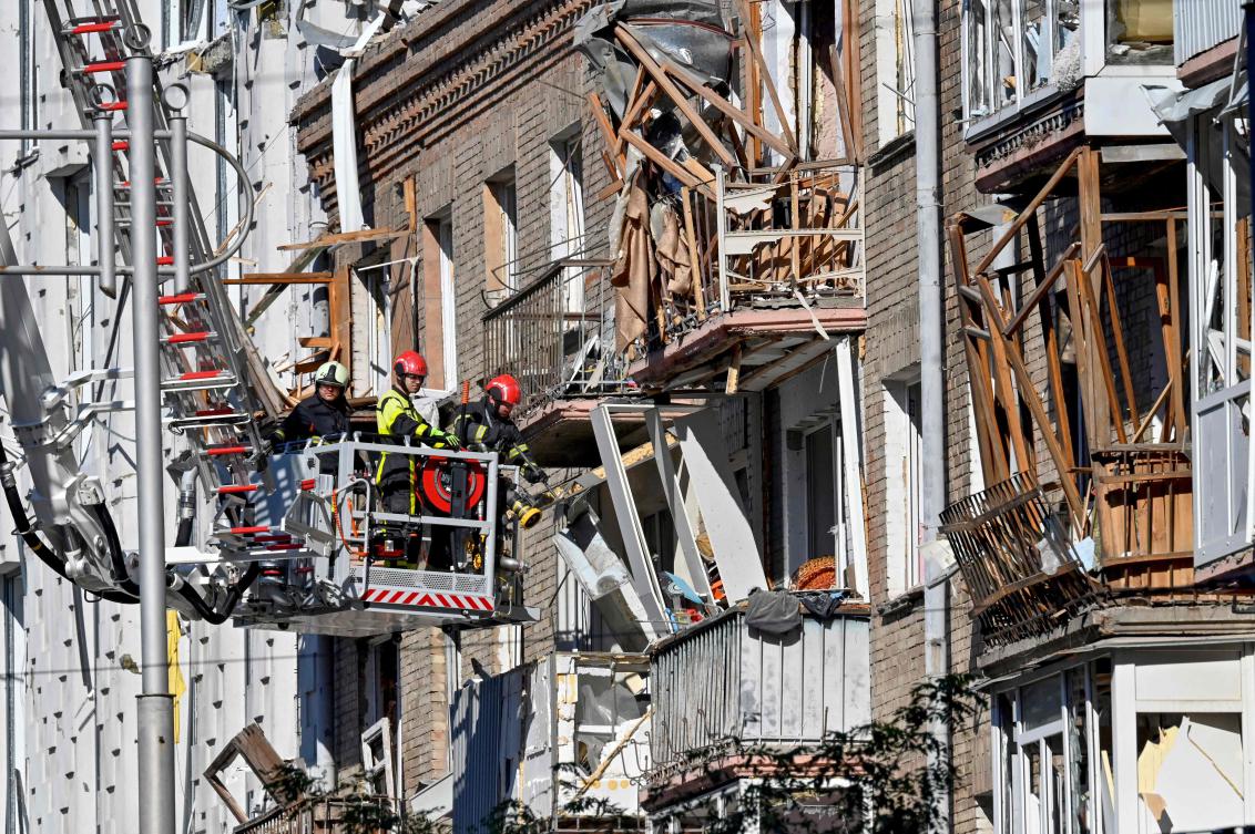 Rescuers clear debris in a residential building in a damaged area of Ukrainian capital following a large-scale Russian drone and missile attacks in Kyiv on Aug. 28, 2025. (AFP)