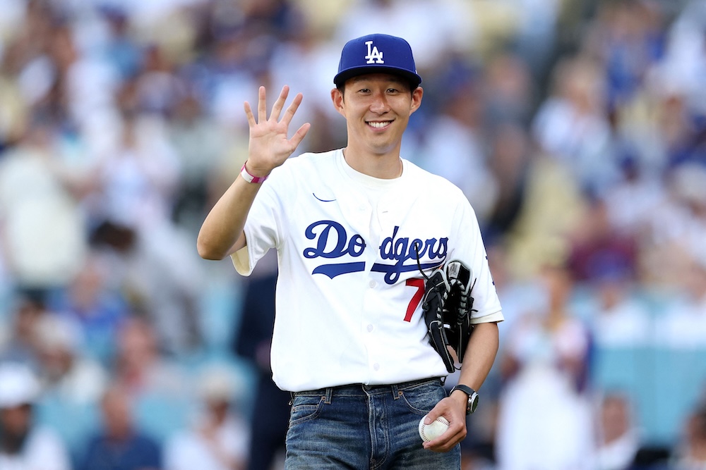 Above, Son Heung-min of Los Angeles Football Club waves before the game between the Los Angeles Dodgers and the Cincinnati Reds at Dodger Stadium on Wednesday in Los Angeles, California. (Getty Images via AFP)