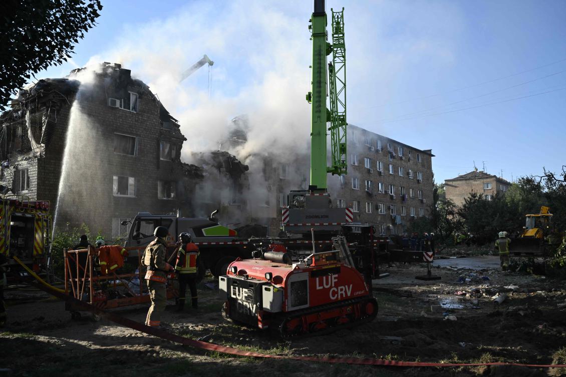 Ukrainian rescuers conduct a search and rescue operation in and around a residential building heavily damaged during a large-scale Russian drone and missile attack on Aug. 28, 2025. (AFP)