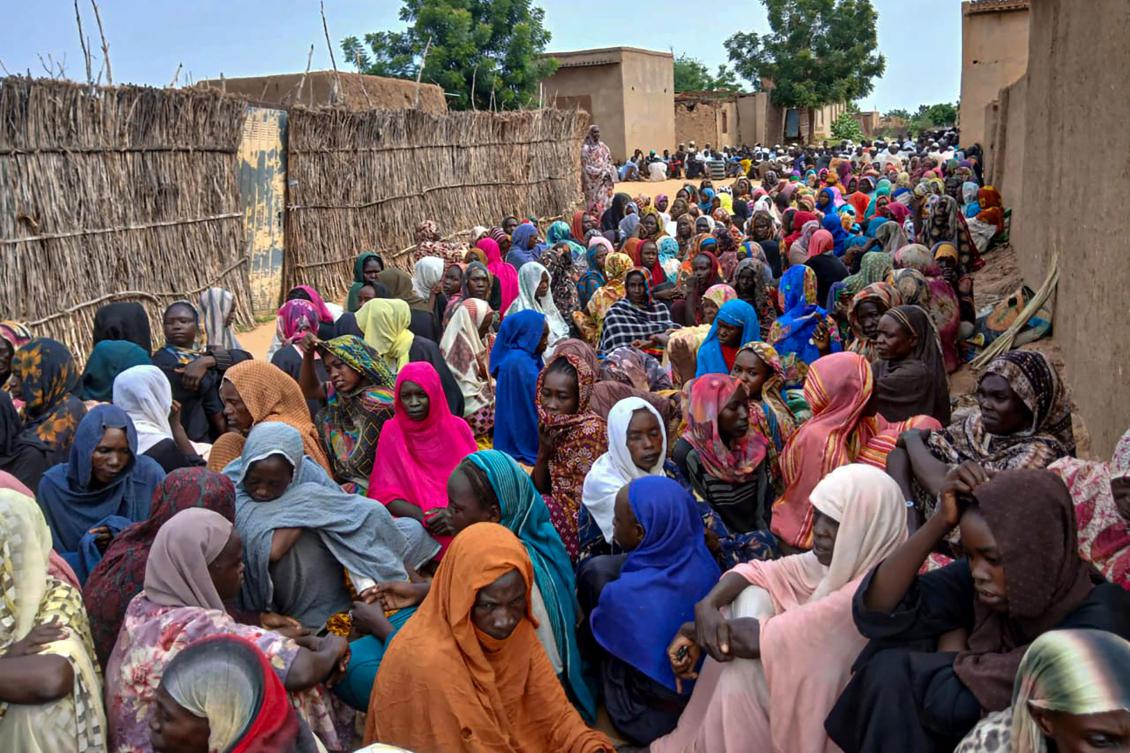 Sudanese residents gather to receive free meals in El-Fasher, a city besieged by Sudan's paramilitary Rapid Support Forces for more than a year, in Darfur region, on August 11, 2025. (AFP)