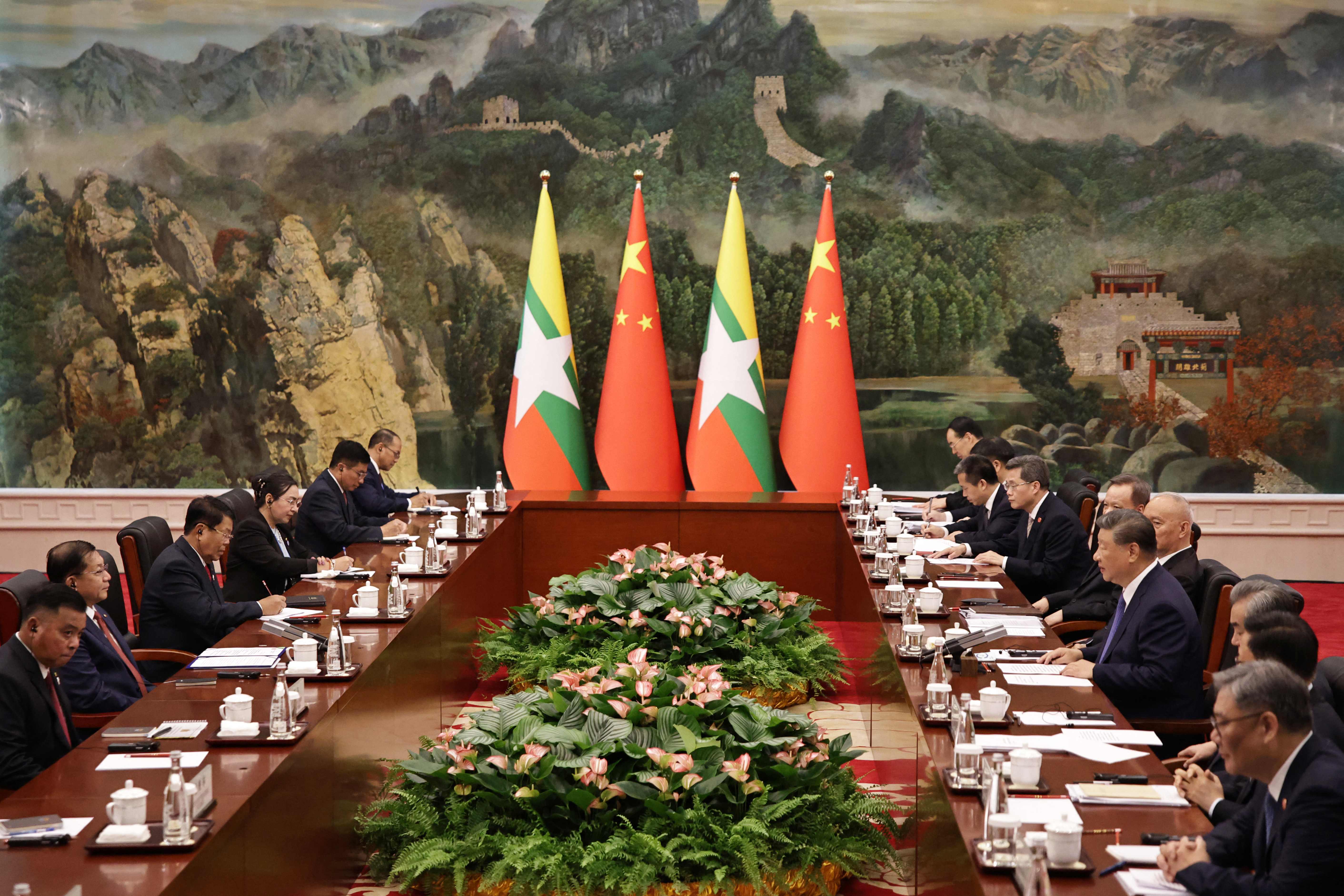 China’s President Xi Jinping (4th R) speaks during a bilateral meeting with Myanmar's junta chief Min Aung Hlaing (2nd L). (AFP)
