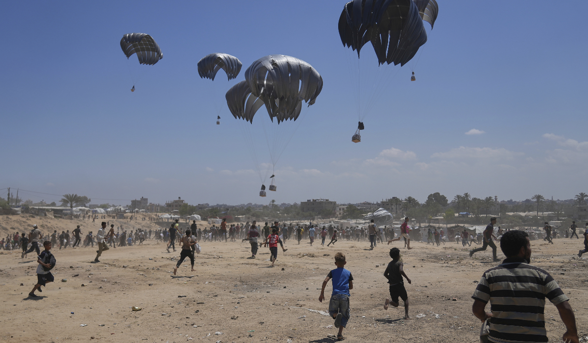 Palestinians rush to collect humanitarian aid airdropped by parachutes into Zawaida in Gaza, Monday, Aug. 4, 2025. (AP)