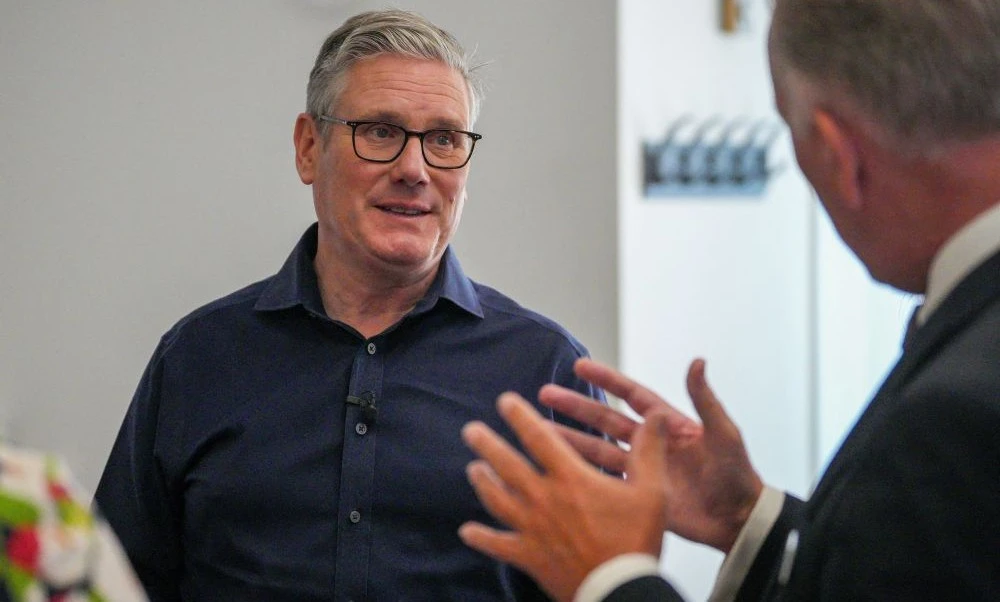Keir Starmer talks to music teachers during his visit to Milton Keynes Central Library, Aug. 06, 2025. (Reuters)
