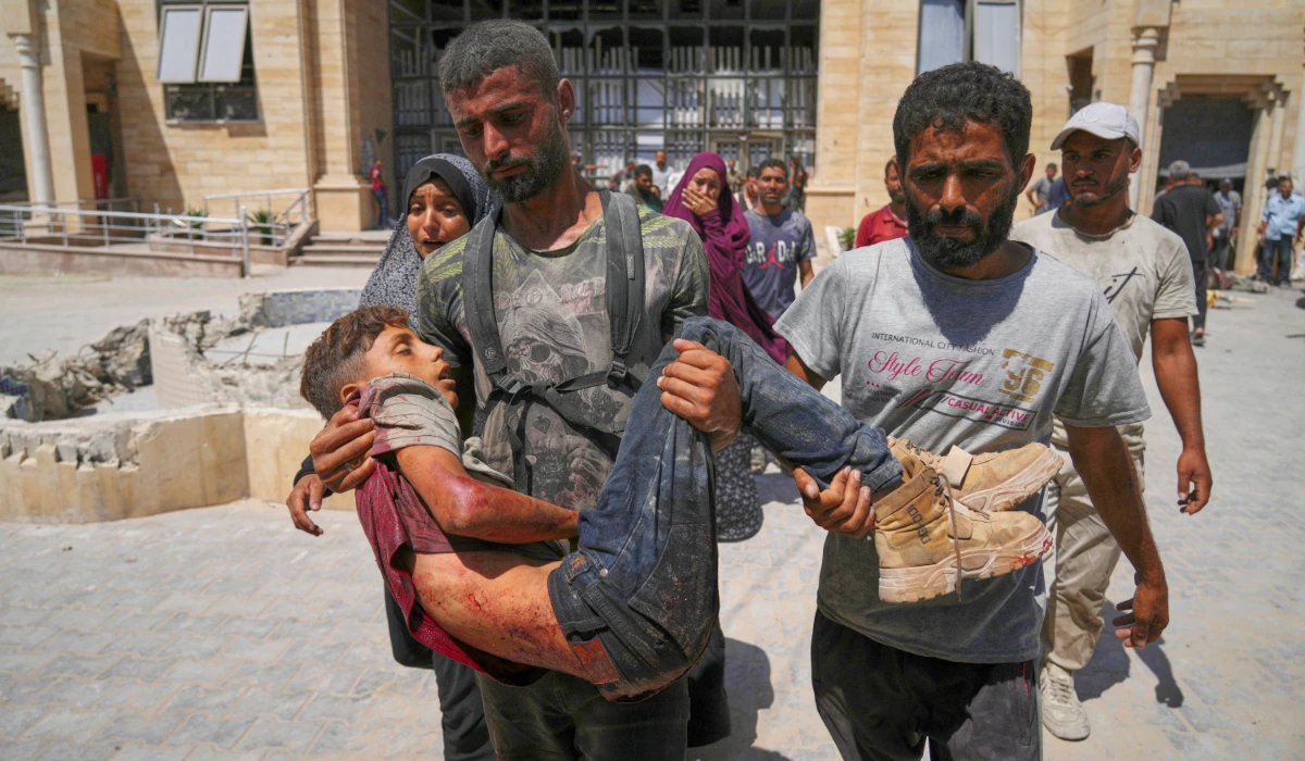 A Palestinian carries the body of a youth killed while trying to reach trucks carrying humanitarian aid en route to Gaza City, outside the Hamad Al-Qatari Hospital in Beit Lahiya, northern Gaza Strip, Friday, Aug. 1, 2025. (AP)