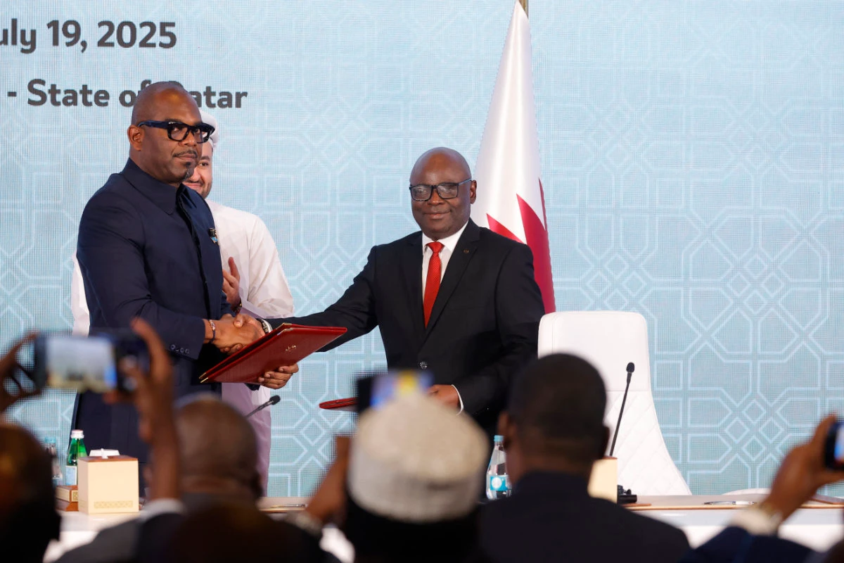 Peace mediator Sumbu Sita Mambu, a high representative of the head of state in the Democratic Republic of Congo (L), and Rwanda-backed armed group M23 executive secretary Benjamin Mbonimpa (R) shake hands after signing a ceasefire deal in the Qatari capital Doha on July 19, 2025 to end fighting that has devastated the country's mineral-rich but conflict-torn east. (AFP)