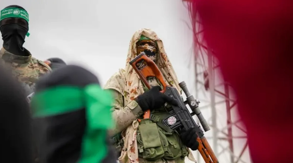 Hamas fighter in combat fatigues stands before the ceremony for the handover of Israeli hostages to the Red Cross in Nuseirat in February. (AP/File Photo)