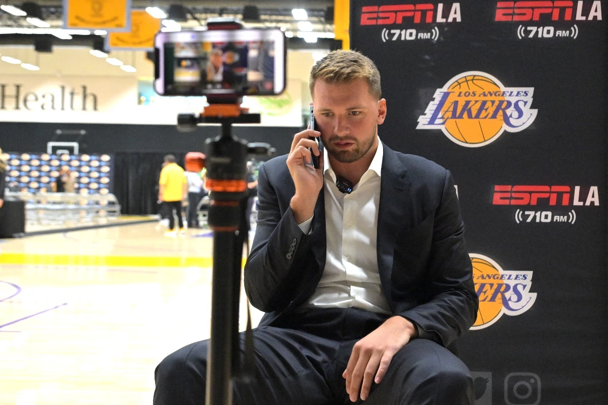Los Angeles Lakers Luka Doncic is interviewed by ESPN LA radio following a press conference announcing the signing of a 3-year, $165 million contract extension at UCLA Health Training Center Saturday. (Imagn Images)