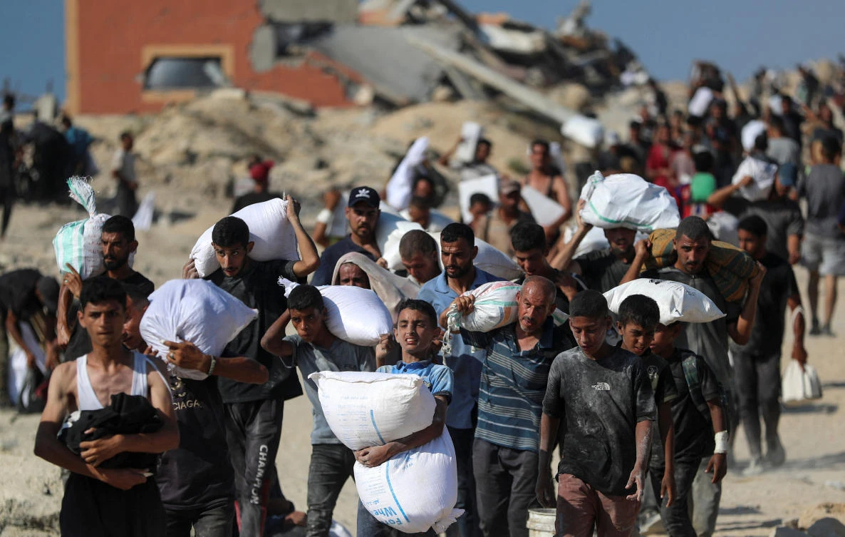 The trickle of food aid Israel allows to enter Gaza after nearly 22 months of war is seized by Palestinians risking their lives under fire. (REUTERS)