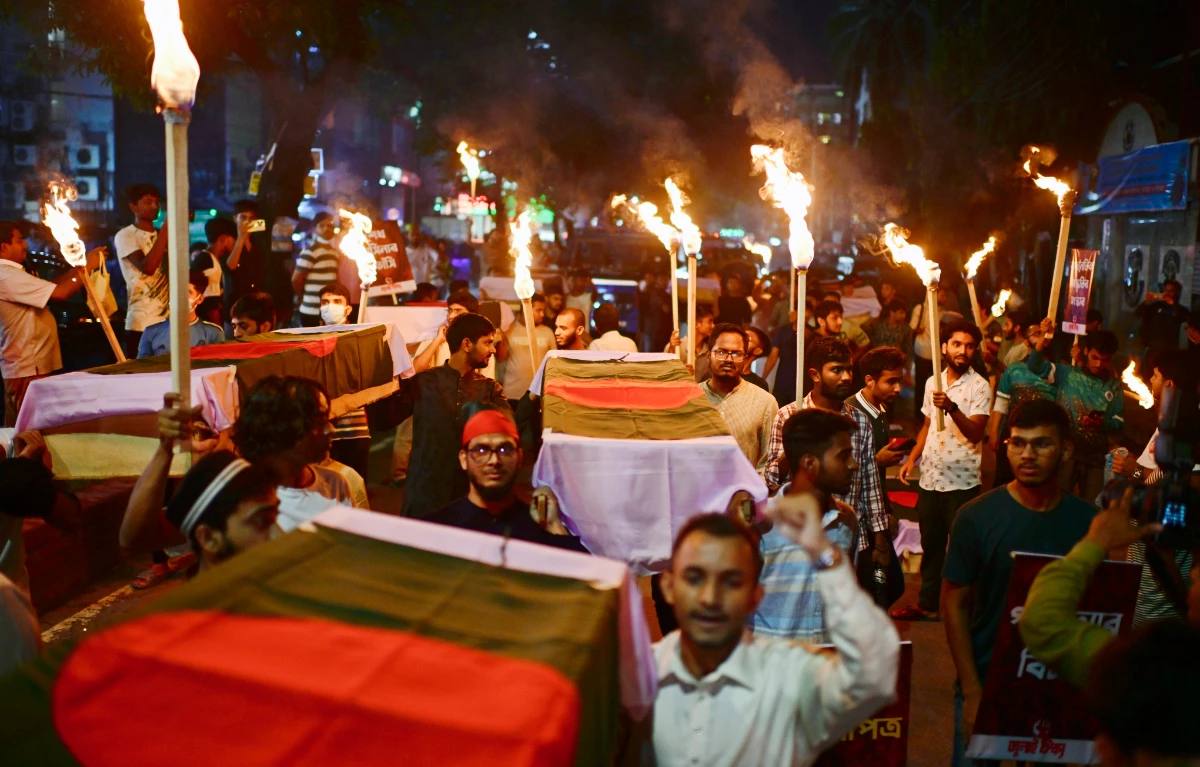 In this July 16, 2025 photo, activists carry symbolic coffins and torches during a procession to mark the day of a student-led protest one year ago, in Dhaka, Bangladesh. (AP)