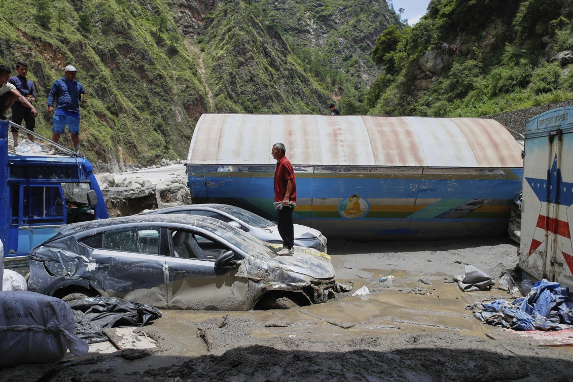 Damaged vehicles are visible after severe monsoon rains flooded the Bhotekoshi River and swept away a key bridge connecting the country with China in Rasuwagadi, north of the capital, Katmandu, Nepal, July, 9, 2025. (AP/File)