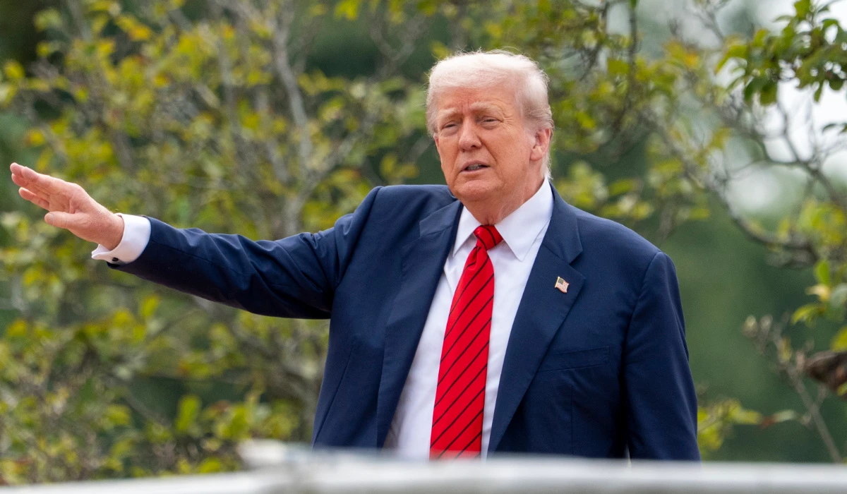President Donald Trump shouts to reporters as he surveys the grounds from the roof above the Colonnade that goes to the West Wing of the White House, Tuesday, Aug. 5, 2025, in Washington. (AP)