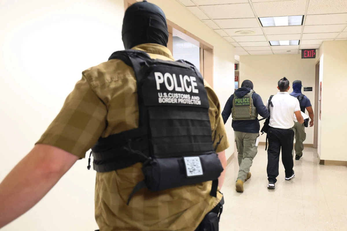 Federal agents detain a person exiting a court hearing at immigration court at the Jacob K. Javitz Federal Building on August 06, 2025 in New York City. (Getty Images via AFP)