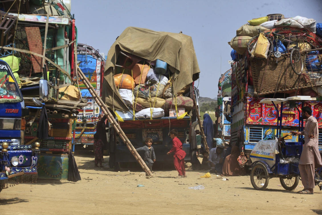Afghan refugee children play next to trucks loaded with their family's belongings as they wait to return Afghanistan along a highway in Landi Kotal, Pakistan, April 9, 2025. (AP)