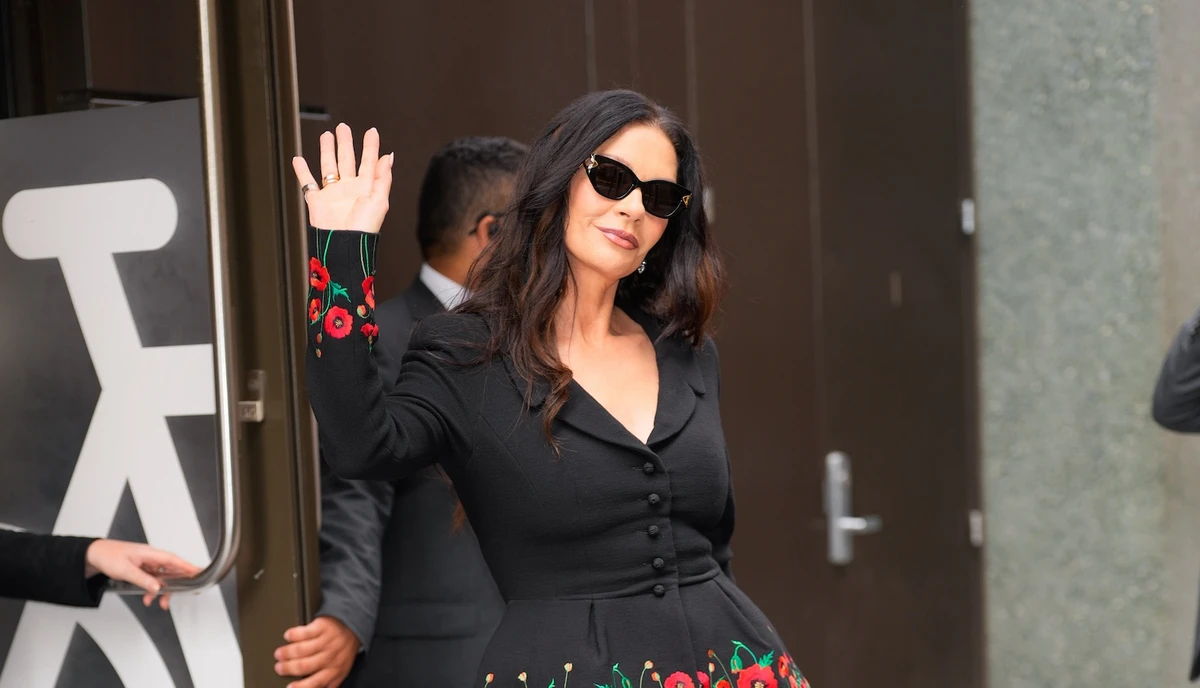 She opted for the Lily shades, a bold, oversized cat-eye design in glossy black acetate with dark lenses and gold logo detailing on the temples. (Getty Images)
