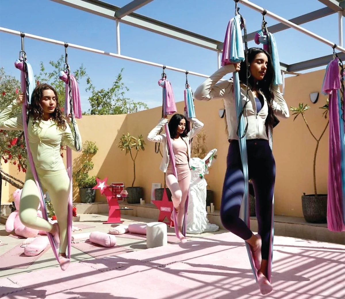 Outdoor aerial Pilates sessions combine traditional poses with hammock support to improve core strength and balance. (Supplied/Instagram/sunsets_yoga)