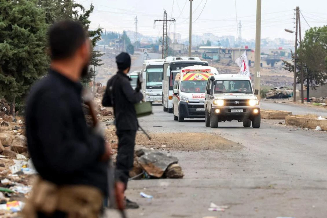 This handout picture released by the official Syrian Arab News Agency (SANA) on July 21, 2025 shows a convoy of buses led by a vehicle and ambulance of the Syrian Red Crescent carrying evacuated Bedouin families in southern Syria's Sweida as security forces deploy in the area. (AFP)