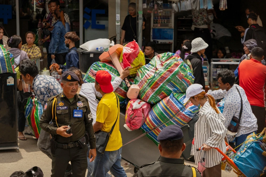 Military policemen patrol the main road of Kamrieng as migrant workers re-enter Cambodia through the Daung International Border Check Point between Cambodia and Thailand. (AP)
