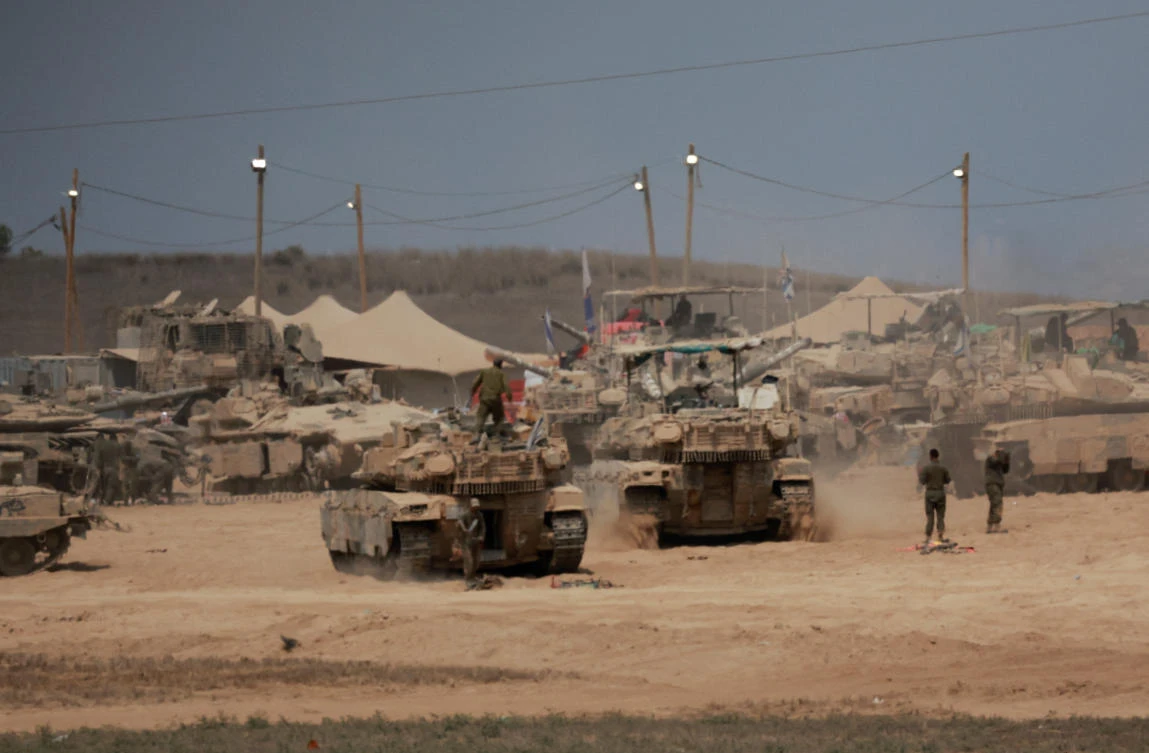 Above, military vehicles on the Israeli side of the border with Gaza on Aug. 12, 2025. (Reuters)