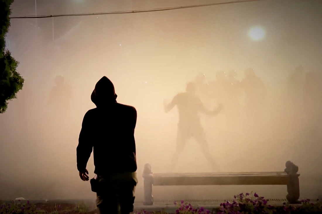 An image taken from video shows protesters and riot police engulfed by smoke as clashes erupted at protests in Vrbas, Serbia. (N1 Serbia via AP)