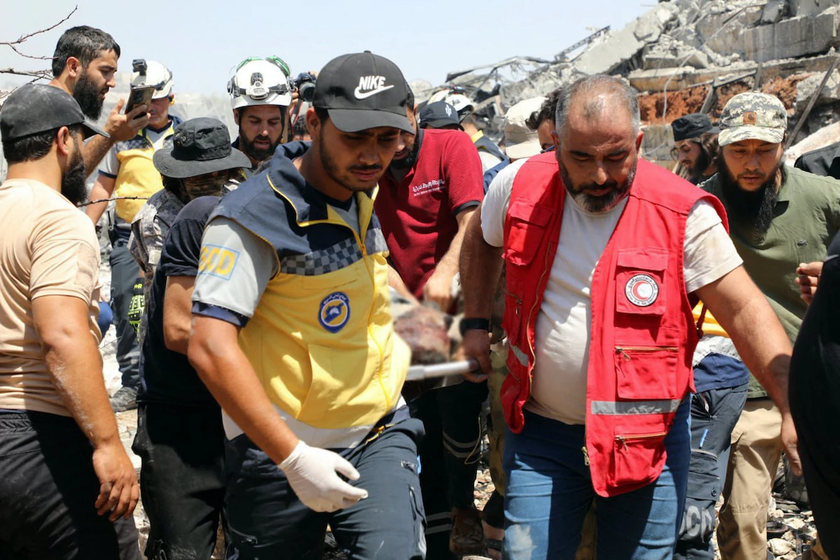 Rescue teams carry away victims from an explosion that rocked Idlib in northwest Syria on Thursday. (Via AFP)