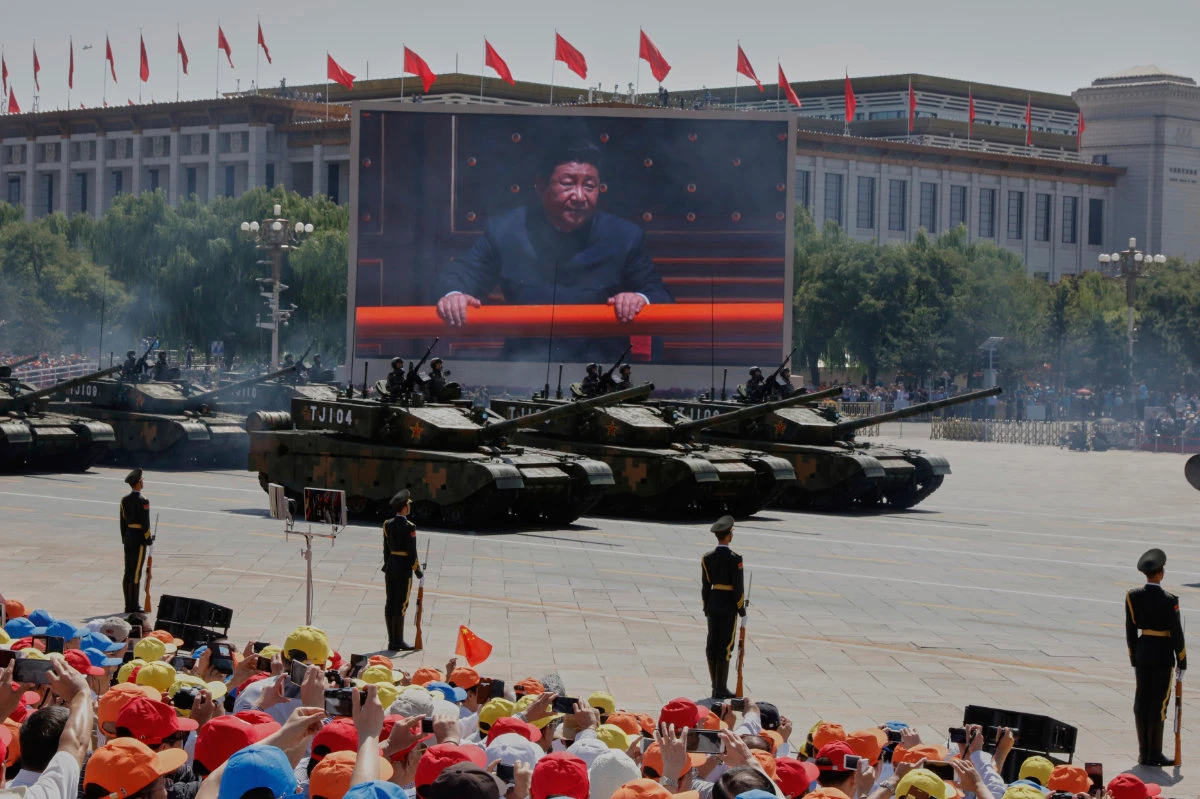 Chinese President Xi Jinping is displayed on a screen as Type 99A2 Chinese battle tanks take part in a parade in Beijing. (AP file photo)