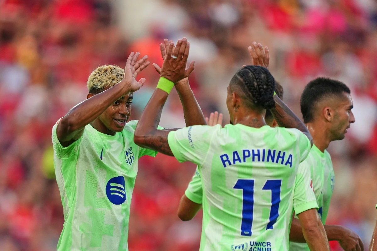 Barcelona’s Lamine Yamal left, and Raphinha celebrate after a goal during the La Liga football match between Mallorca and Barcelona in Mallorca Saturday. (AP)